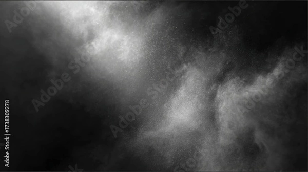 Fototapeta A dynamic cloud of white powder or dust disperses dramatically against a dark background, creating a textured and ethereal visual effect.