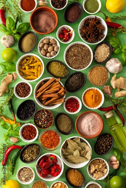 Fototapeta Brightly colored spices and herbs arranged on a delicate green background, highlighting their freshness and fragrance for a lively, natural look