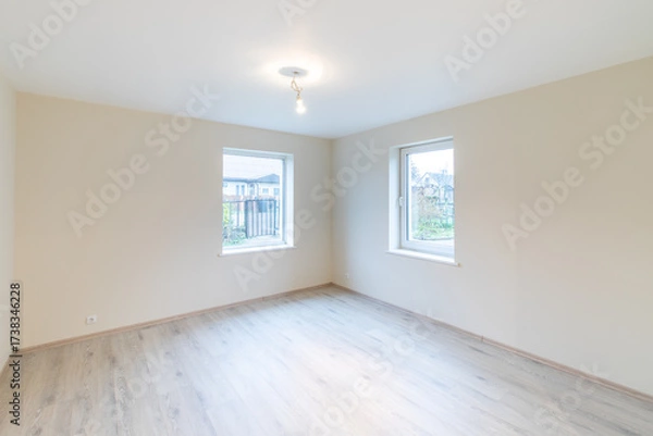Fototapeta Modern New Construction Empty Room With Wooden Flooring and Large Windows. Home Interior