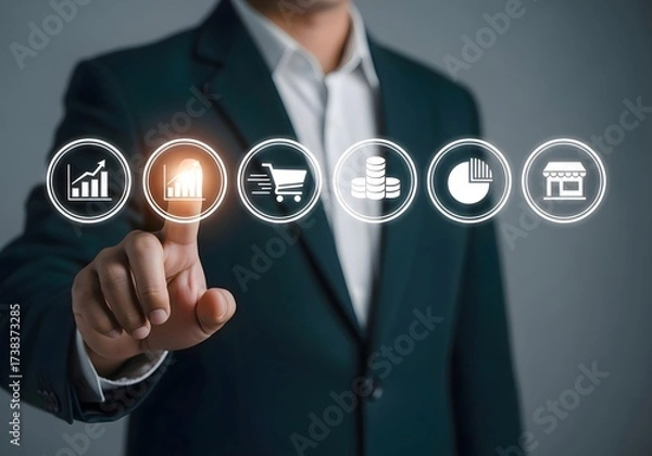 Fototapeta Man in suit pointing at glowing chart icon among other business related icons in a digital display