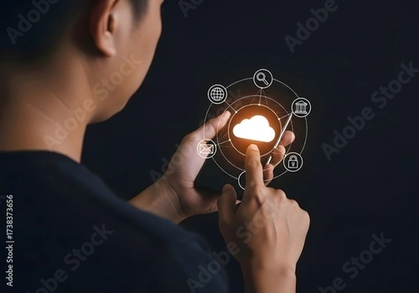 Fototapeta Man interacting with a digital cloud interface with various icons on a dark background image view