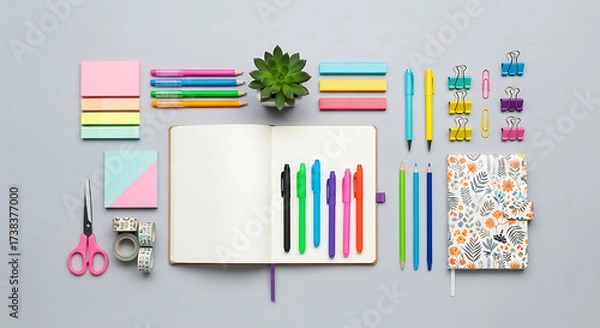 Obraz Overhead shot of an open notebook surrounded by colorful stationery, including pens, sticky notes, scissors, and decorative tape perfect for creative projects and organization