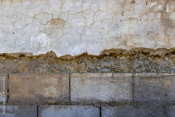 Fototapeta Weathered plastered and brick wall showing damage under sun light
