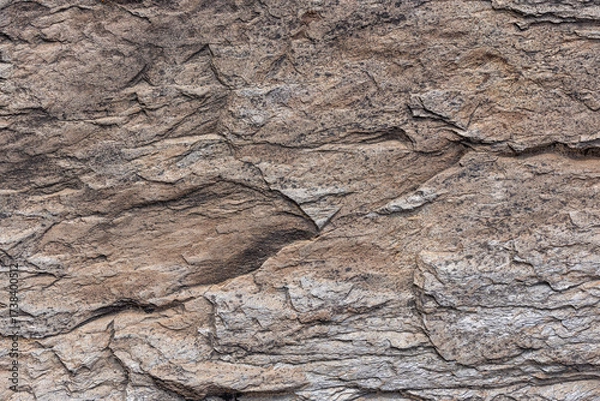 Fototapeta Rough sedimentary stone face texture and full-frame closeup background