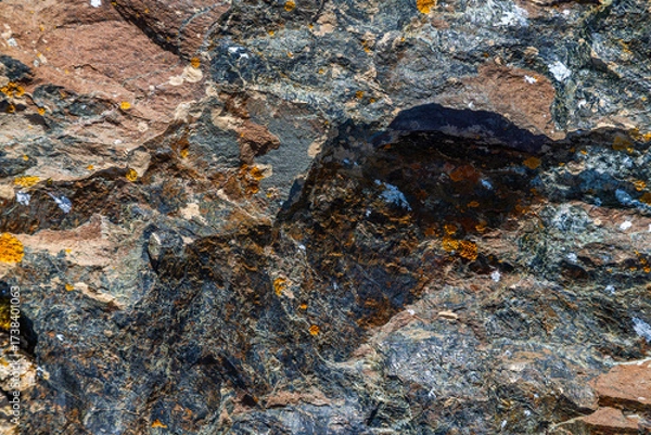 Fototapeta Rugged rock surface with lichen in natural outdoor setting