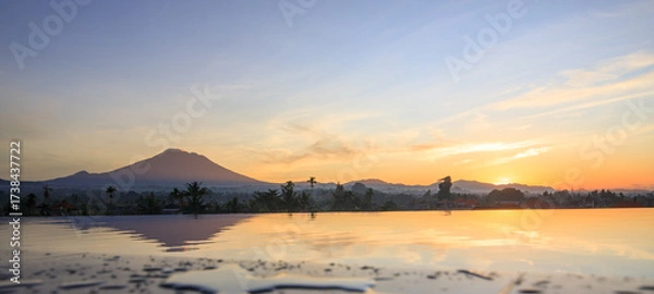 Fototapeta Beautiful sunset over a lake with a mountain in the background