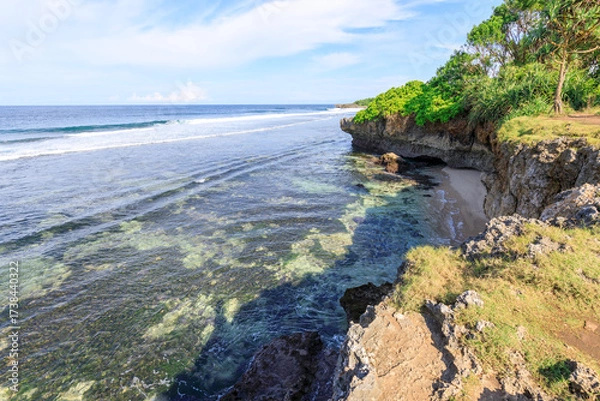 Fototapeta Beautiful beach with a rocky cliff in the background
