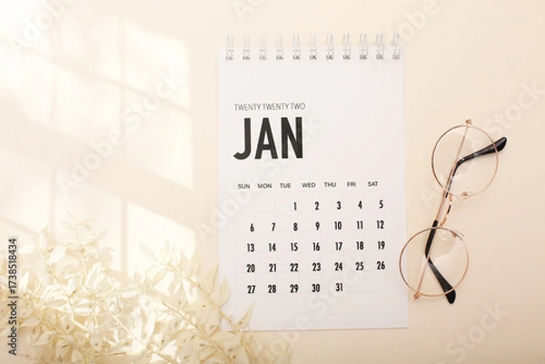 Fototapeta Desktop calendar on a modern desktop. Schedule and time planning in office and business.