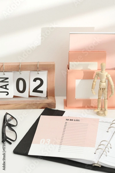 Fototapeta Desktop calendar on a modern desktop. Schedule and time planning in office and business.