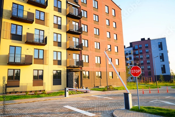 Fototapeta Automatic car barrier in Private urbanization residential area. Car barrier in Condominium. Open barrier at exit from residential. Barrier for entry, exit to parking lot for residents condo building.
