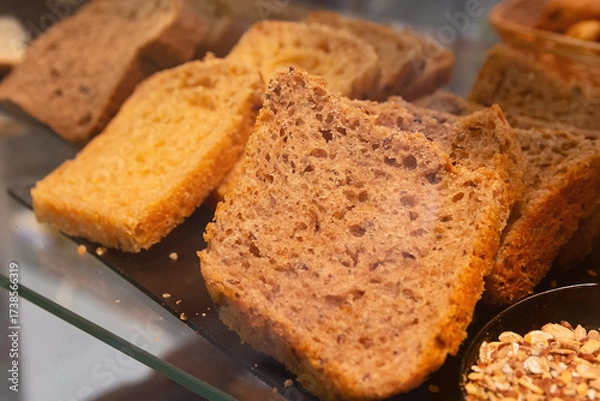 Fototapeta A slice of hearty, sweet bread in the window of a bakery