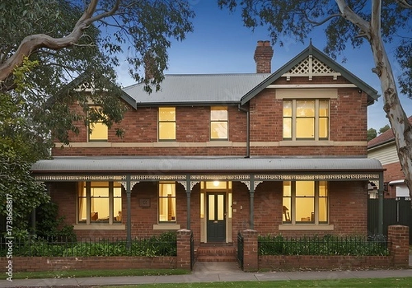 Fototapeta Australian federation style brick house. The home features verandahs and bay window