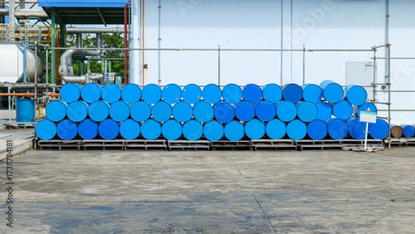 Fototapeta Stacked chemical storage tanks arranged in multiple layers in a storage yard at a chemical factory, representing industrial safety,
