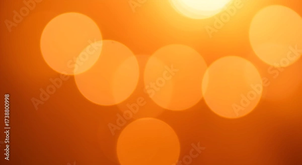 Fototapeta Warm Orange Bokeh Circles Created by Sunlight on a Soft Background for a Calming Atmosphere