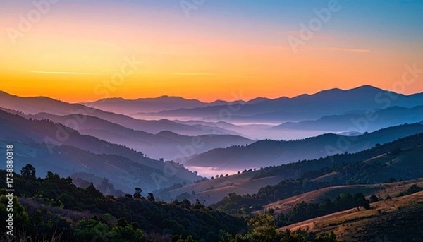 Fototapeta Serene Mountain Range at Sunrise with Colorful Sky and Misty Valleys Aerial View