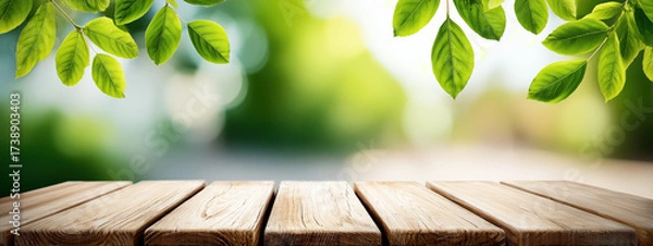 Fototapeta Banner of Natural Background with Wooden Table and Green Leaves for Product Display or Photography