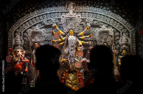 Fototapeta Devotees  throng to offer prayers to Goddess Durga at a pandal during Durga puja festival