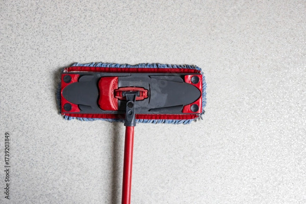 Fototapeta Cleaning tool for floors positioned on smooth surface ready for use in home or office cleaning activity