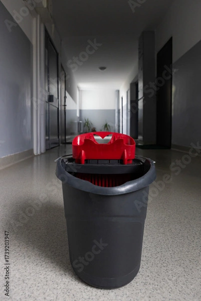 Fototapeta Cleaning supplies in a hallway during a maintenance routine in a building
