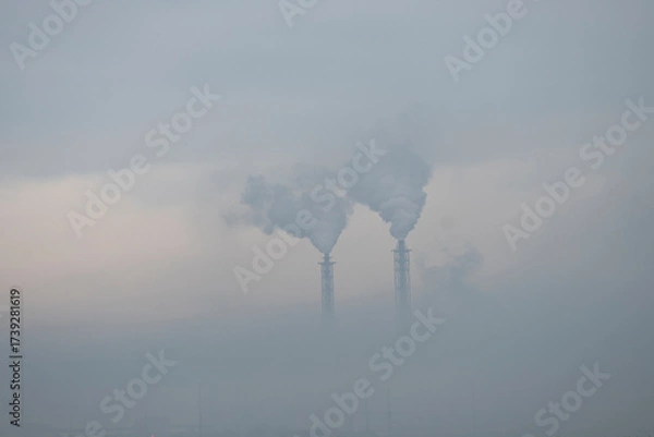 Fototapeta a factory in the distance. Smoking chimneys