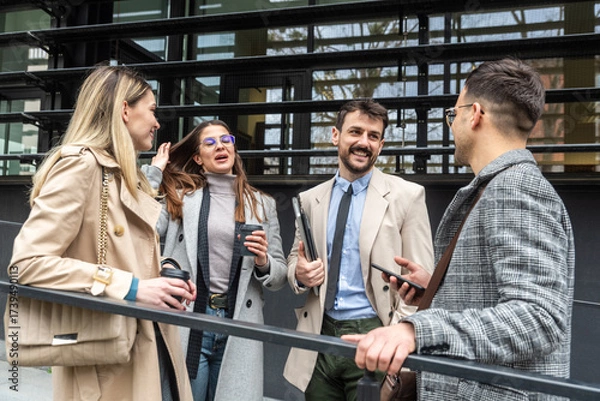 Fototapeta IT experts freelance workers innovative technology developers, working on a new project staff meeting with casual talk in formalwear outside office building before the work. Discussing business people