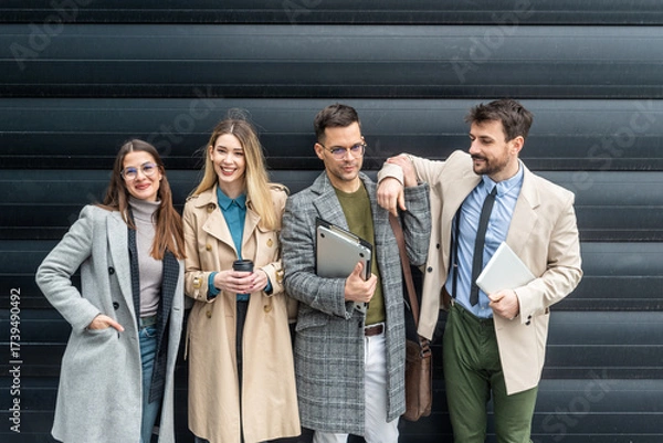 Fototapeta IT experts freelance workers innovative technology developers, working on a new project staff meeting with casual talk in formalwear outside office building before the work. Discussing business people