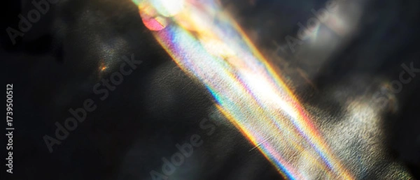 Fototapeta Abstract light refraction with vibrant rainbow streaks on a dark textured background. A dreamy, ethereal visual for creative, tech, or spiritual concepts.
