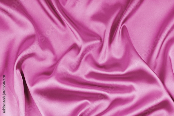 Fototapeta Crumpled, wrinkled pink colored glossy silk satin texture. Shiny smooth fabric with soft folds, cloth with wave drapery. Elegant and rich background, wallpaper, backdrop. Flat lay, top view