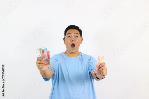 Fototapeta Asian Man with Indonesian Rupiah pointing finger with excitement gesture