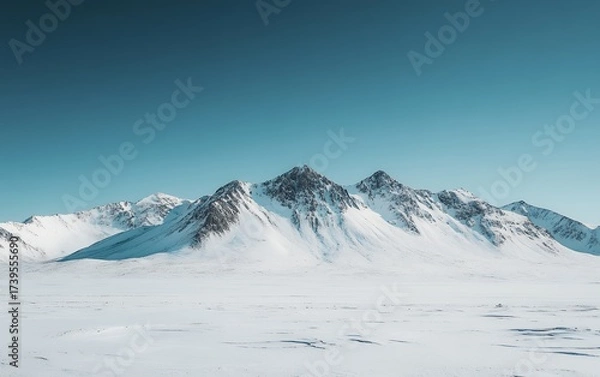 Obraz Panoramic view of snow-covered mountain peaks against a pristine blue sky, showcasing the serene beauty and grandeur of a winter landscape