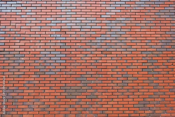 Obraz A red brick wall. The background of a solid barrier.