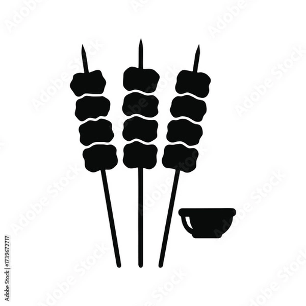 Fototapeta Three skewers with food, next to a small bowl.