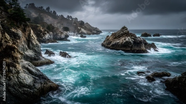 Fototapeta Coastal landscape showcases rugged cliffs meeting the dynamic ocean under a dramatic, overcast sky, creating a scene of natural power and serenity.