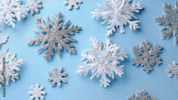 Fototapeta A blue background with many snowflakes on it