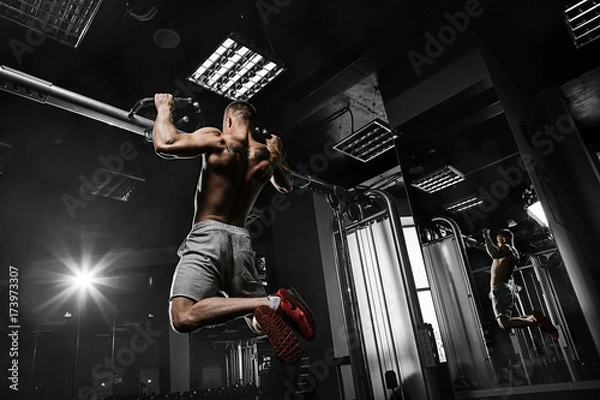 Obraz Strong man with tatoo working in gym 