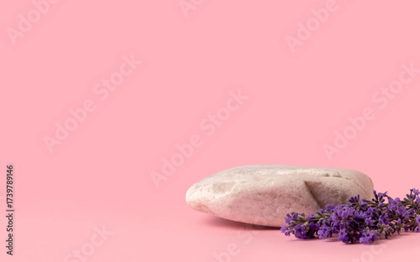 Fototapeta Beauty cosmetics product presentation scene made with lilac flowers and stone on soft pink background with copy space