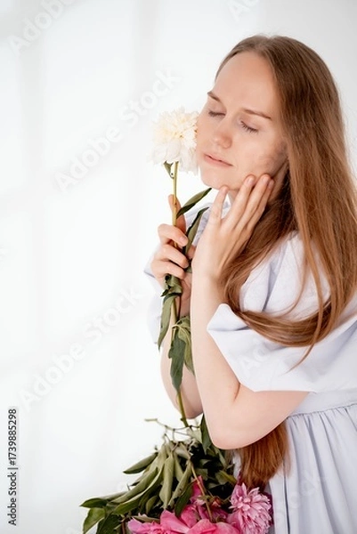 Obraz a young beautiful girl with peony flowers on a white isolated background, space and room for text