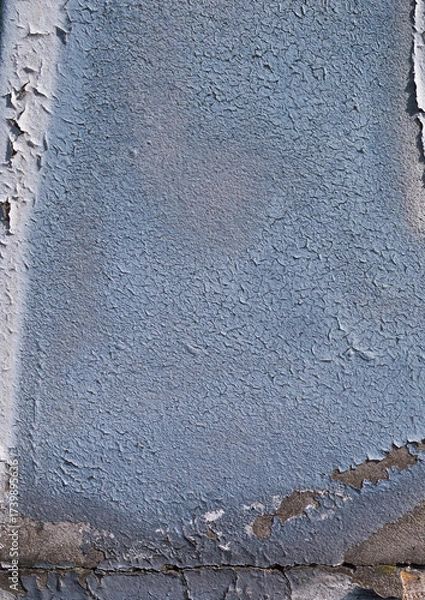 Fototapeta cracked and peeling paint on a wall surface. The weathered texture shows layers of faded blue and white paint flaking off, revealing an aged and distressed background. Perfect as a grunge overlay.