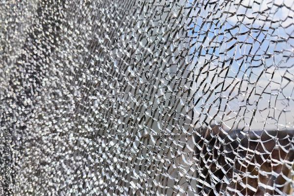 Obraz Shattered glass reflects the sky and surrounding buildings in a cityscape
