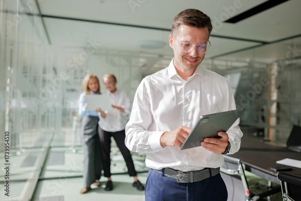 Fototapeta Business team collaborating in modern office space with technology