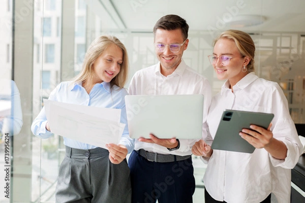 Fototapeta Business team collaborating in modern office space with technology