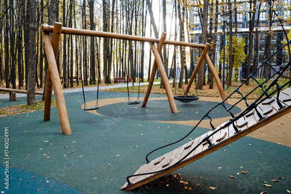 Fototapeta Modern Playground Equipment Made of Wood, Nestled Amongst Nature, Creating an Inviting Atmosphere During the Beautiful Autumn Season, Perfect for Fun Activities, Leisure, and Recreation
