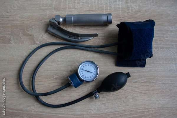 Fototapeta There is a tonometer and a laryngoscope on the table. Horizontal shot.