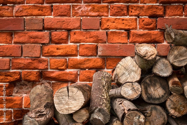 Obraz Logs on the background of a brick wall