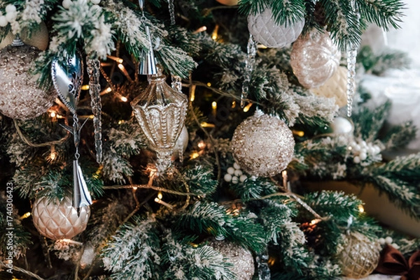 Fototapeta Festive decorations adorn a Christmas tree with sparkling ornaments and warm lights