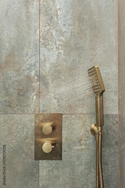 Fototapeta Walk-in shower with a minimalist enclosure, built-in thermostatic mixer tap, and a full  wall paneling in natural  tones