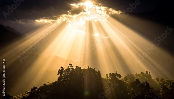Obraz Rays of Sunlight Piercing Through Clouds Over a Forest.