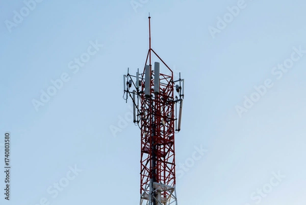 Fototapeta Telecommunication tower with antennas under blue sky