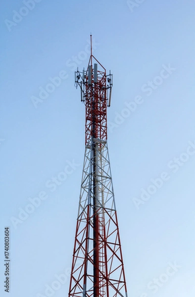 Fototapeta Telecommunication tower with antennas under blue sky