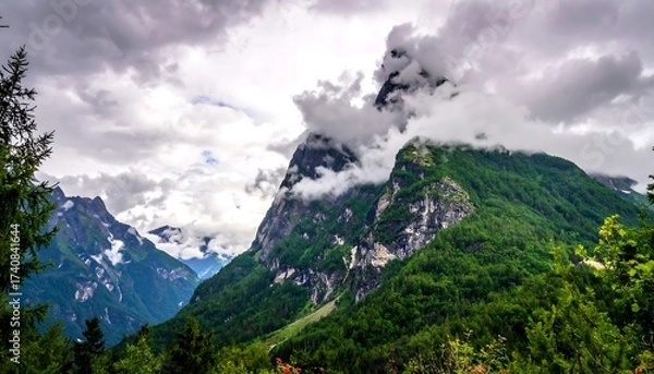 Fototapeta Dramatic mountain landscape with clouds, trees, and scenic natural environment